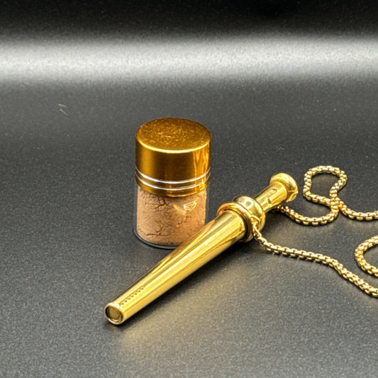 Gold necklaces with BumpHit pendants on a dark background